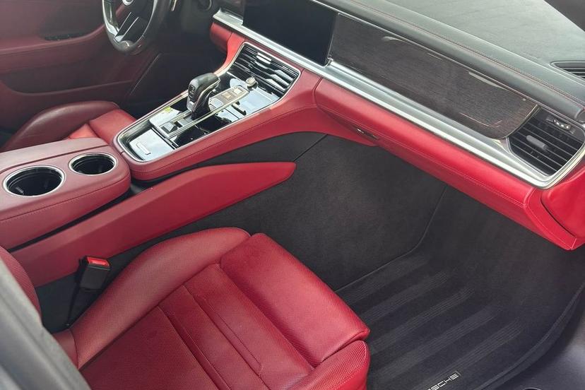 Spotless Porsche Panamera interior with red leather seats and a clean black carpet